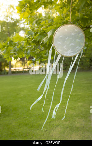 Lace Dream Catcher hanging from a tree in a Garden Stock Photo