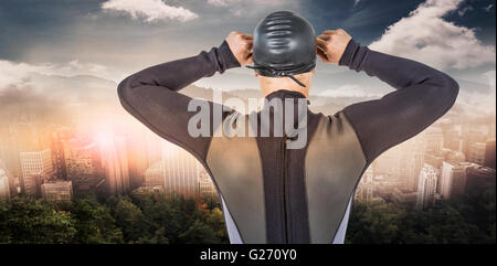 Composite image of rear view of swimmer in wetsuit wearing swimming goggles Stock Photo