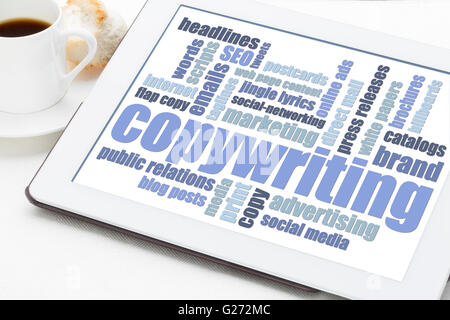 copywriting word cloud in blue and white on a digital tablet with a cup of coffee Stock Photo