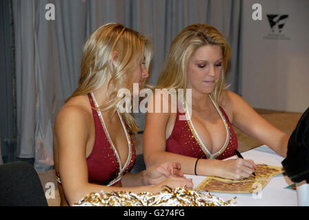 Two of the Washington Redskins cheerleaders sign autographs at the auto show in Washington, DC Stock Photo