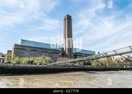 LONDON, UK - AUGUST 22, 2015: Tate Modern and Millennium Bridge in London from the river a sunny day. Stock Photo