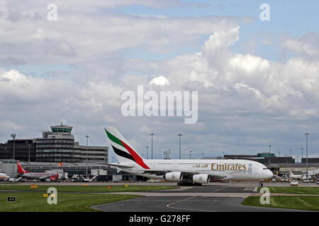 Emirates Airlines Airbus A380-861 airliner leaving terminal at Manchester International Airport Stock Photo