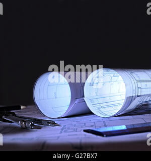 architectural plans on a table an office at dawn Stock Photo