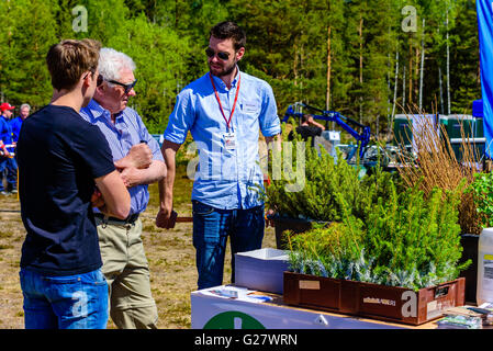 Emmaboda, Sweden - May 13, 2016: Forest and tractor (Skog och traktor) fair. Salesperson at Sundins Skogsplantor talking to visi Stock Photo