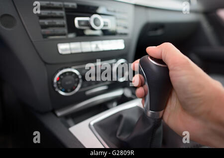 Driver shifting the gear stick in car Stock Photo