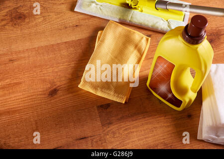 Tools and products for the maintenance of wooden floors. With brightening, rag, mop and chamois on wooden floor. Elevated top Stock Photo