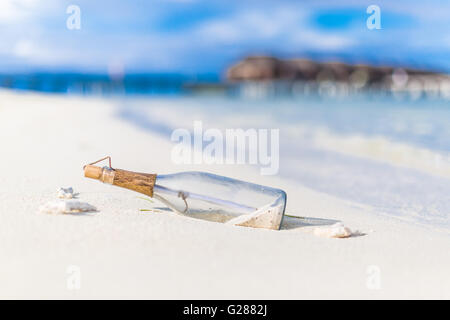 Message in a Bottle on the sandy beach. Message in a Bottle. Beach background concept Stock Photo