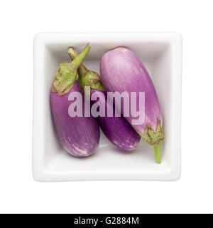 Mini eggplants in a square bowl isolated on white background Stock Photo