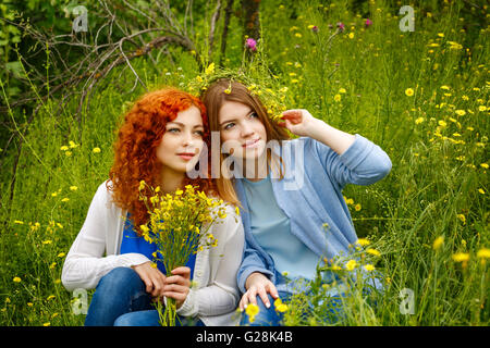 Best friends forever. Friends sitting on the grass in the park. BFF. Close friends Stock Photo
