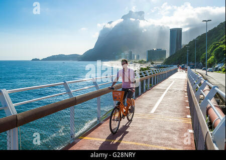 RIO DE JANEIRO - MARCH 19, 2016: A cyclist rides on the newly completed Ciclovia Tim Maia bike path, an Olympics legacy project. Stock Photo