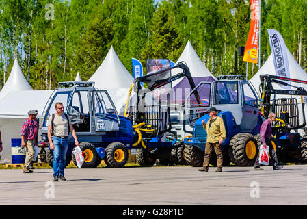 Emmaboda, Sweden - May 13, 2016: Forest and tractor (Skog och traktor) fair. Novotny forwarders with people walking by in front. Stock Photo