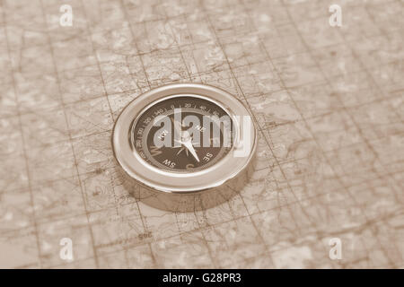 Orienteering using a map and compass. Magnetic compass on a topographic map. Stock Photo