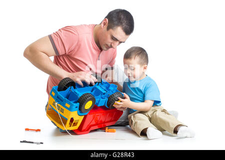 kid boy and his daddy fixing toy trunk Stock Photo