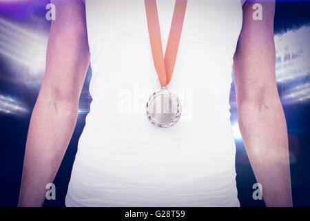 Composite image of female athlete wearing a medal Stock Photo