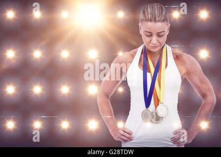 Composite image of female athlete wearing medals Stock Photo