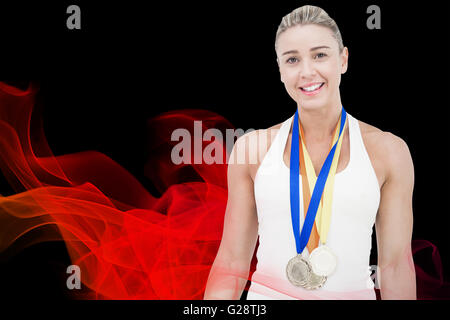 Composite image of female athlete wearing medals Stock Photo