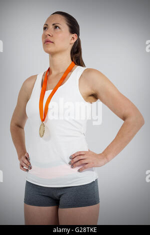 Composite image of athlete posing with gold medals around his neck Stock Photo