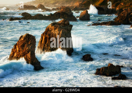 Evening light beauty on the crashing waves and sea stacks at Garrapata State Park along California’s Big Sur Coast. Stock Photo
