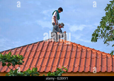 Men working on a roof top. Stock Photo