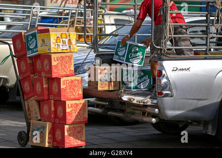 Man loading assorted cases of traditional Thai wines and beer. Thailand S. E. Asia Stock Photo