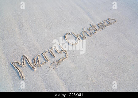 Merry Christmas written on tropical beach sand Stock Photo