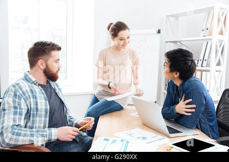 Concentrated young businesspeople working and making new project in office together Stock Photo