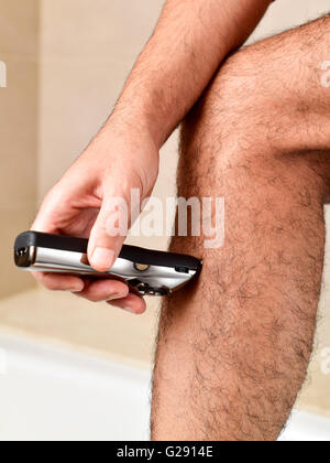 Closeup Of A Young Man Trimming The Hair Of His Pubis With An
