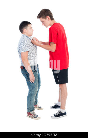 An Older Boy Bullying A Younger Boy With His Fist Clinched Holding ...