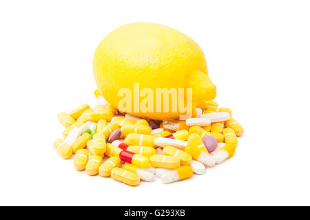 Perfect yellow lemon on bunch of colored pills isolated on white background Stock Photo