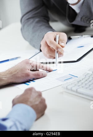 Cropped shot of business colleagues discussing together in an office Stock Photo