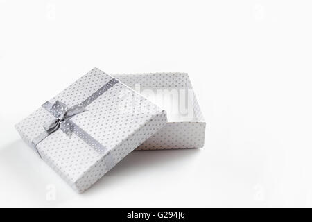 White empty gift box with small circles gray fabric tape with gray tie. isolated white front view Stock Photo