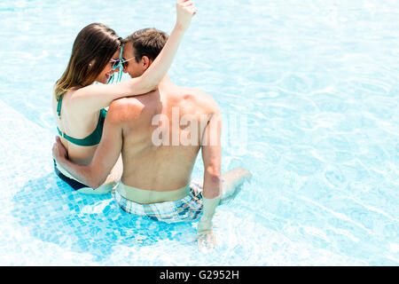 Couple in the pool in the summertime Stock Photo