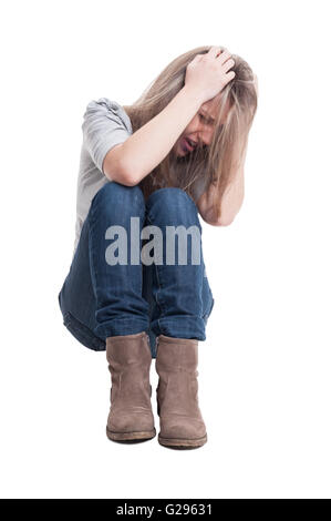 Scared and beaten woman protecting herself isolated on white background Stock Photo