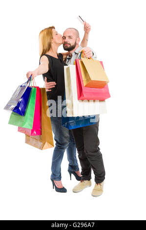 Happy shopping couple using credit card. Consumerism relationship concept on white background Stock Photo