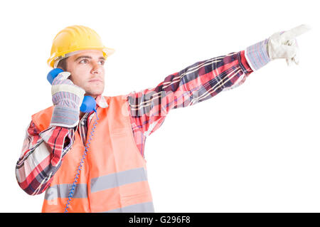 Visionary builder talking on the phone and showing up with the hand Stock Photo
