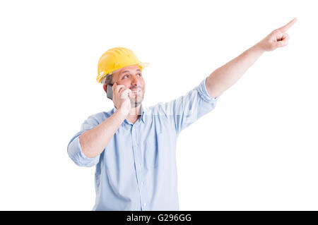 Confident and visionary engineer or architect talking on the phone and pointing finger up Stock Photo