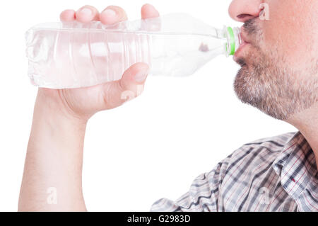 Man drinking cold wather from plastic bottle as summer heat or dehydration concept Stock Photo