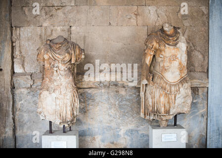 ATHENS, Greece - On left, statue of the personification of Odyssey. On the right, personification of the Iliad. 2nd century AD. Probably from the Library of Paintainos. The Stoa of Attalos is a 1950s recreation of a long pavilion that was originally built around 150 BC. It was part of the Ancient Agora (market). It now houses the Museum of the Ancient Agora, which includes clay, bronze and glass objects, sculptures, coins and inscriptions from the 7th to the 5th century BC, as well as pottery of the Byzantine period and the Turkish conquest. Stock Photo