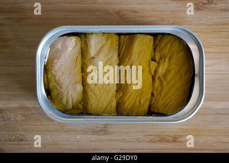 Berlin, Germany. 25th Apr, 2016. An open can of tuna of the brand 'Santa Catarina - Atum Bonito' (S.Jorge, Acores) is on display on a wooden cutting board in Berlin, Germany, 25 April 2016. Photo: Soeren Stache/dpa - NO WIRE SERVICE -/dpa/Alamy Live News Stock Photo