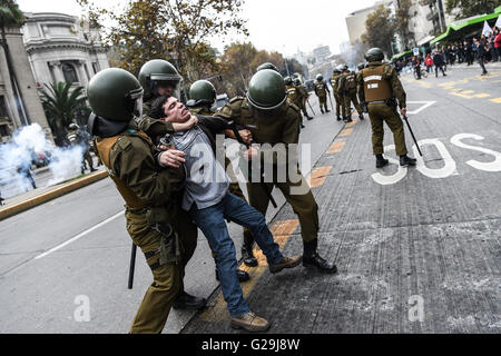 Santiago, Chile. 26th May, 2016. Riot Police arrest a demonstrator during a protest in Santiago, capital of Chile, on May 26, 2016. The protest was called on by different student associations, asking for the President Michelle Bachelet to accelerate the process of the Education Reform, according to local press. Credit:  Jorge Villegas/Xinhua/Alamy Live News Stock Photo
