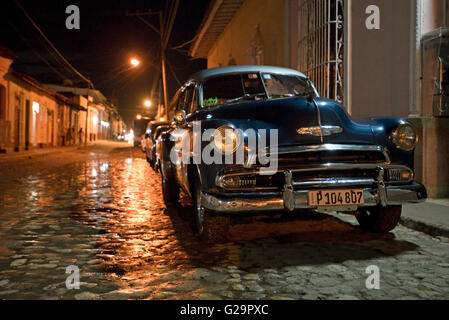 A 1951 Chevrolet Bel Air on a street road near the center of Trinidad in Cuba at night. Stock Photo