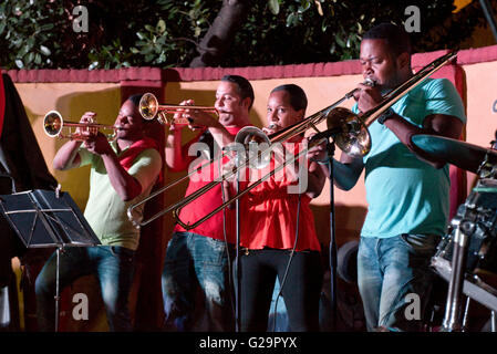 Cuban musicians playing salsa music for locals and tourists at the Casa de la Músíca in Trinidad, Cuba. Stock Photo