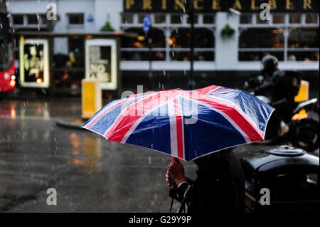 GREAT BRITAIN, London, Notting Hill, pedestrian with umbrella with Union Jack flag during London rain Stock Photo