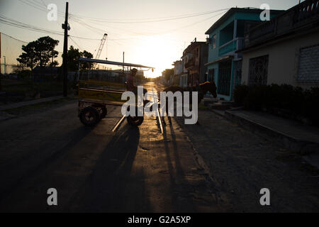 Silhouette of a horse draw cart taxi turning in the street at sunset in Cienfuegos Cuba Stock Photo
