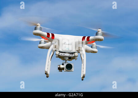 Quadrocopter, drone, with camera flying against a blue sky, DJI Phantom 3 Stock Photo