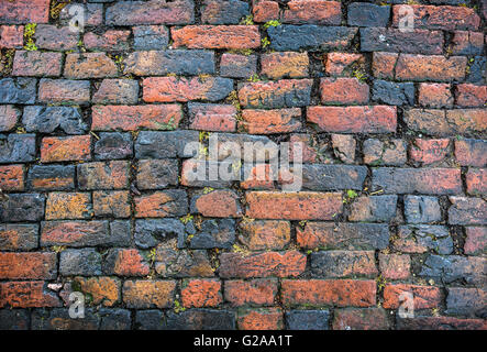 An old brick cobbled road surface. Stock Photo
