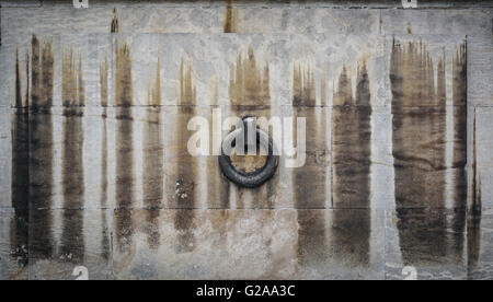 An old stone block wall with a single ring. Stock Photo
