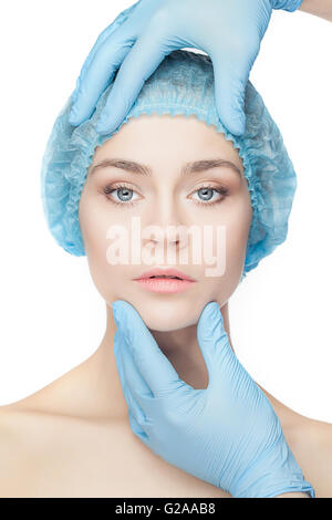 Plastic surgery concept. Doctor hands in gloves touching woman face Stock Photo