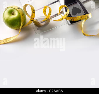 Scale with heart message, apple and tape measure isolated. Concept health, diet and nutrition. Square composition. Top view Stock Photo
