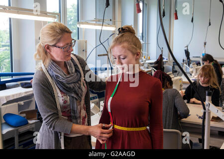 Fitting during the practical training for tailors Stock Photo